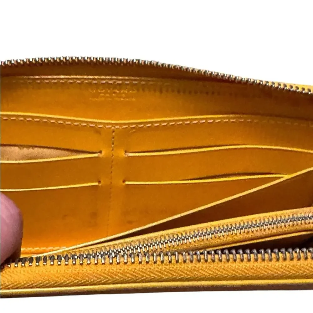 Goyard Matignon zip-around wallet in yellow orange Goyardine canvas.